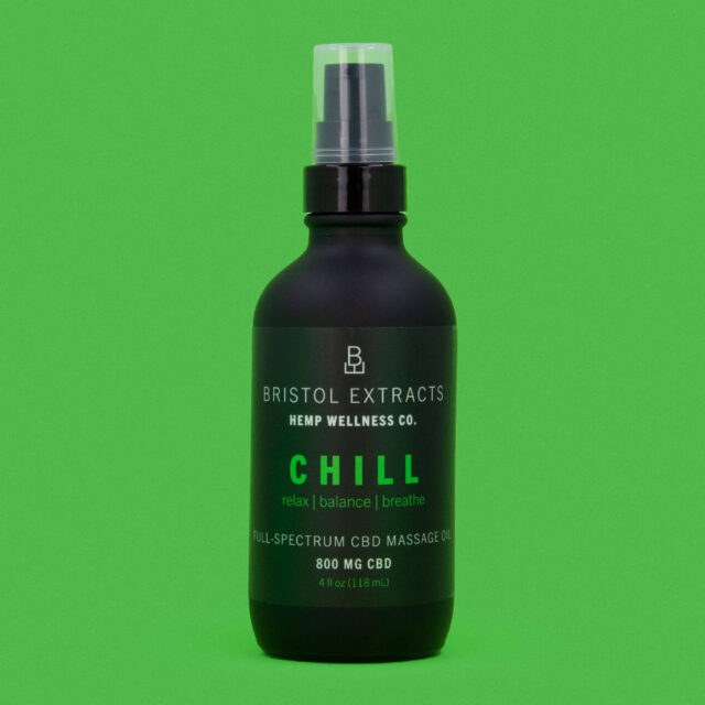 chill massage oil bottle on green background